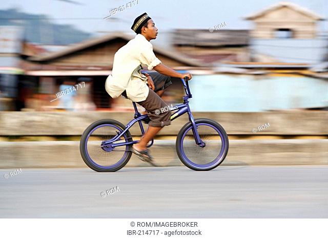 Boy on bicycle, Tenggarong, East-Kalimantan, Borneo, Indonesia