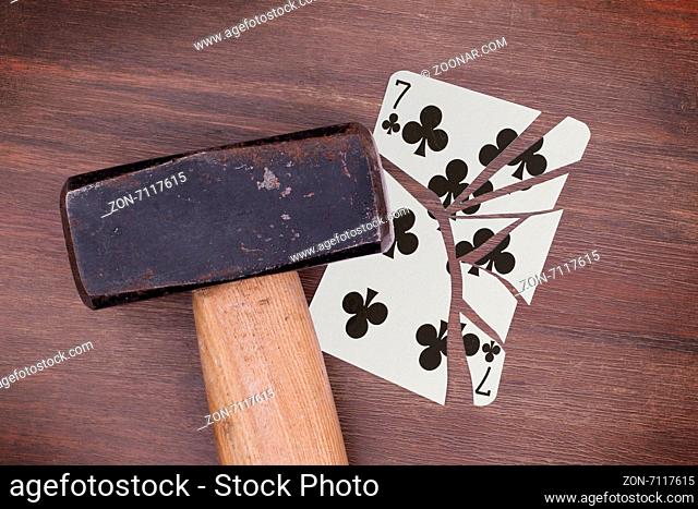 Hammer with a broken card, vintage look, seven of clubs