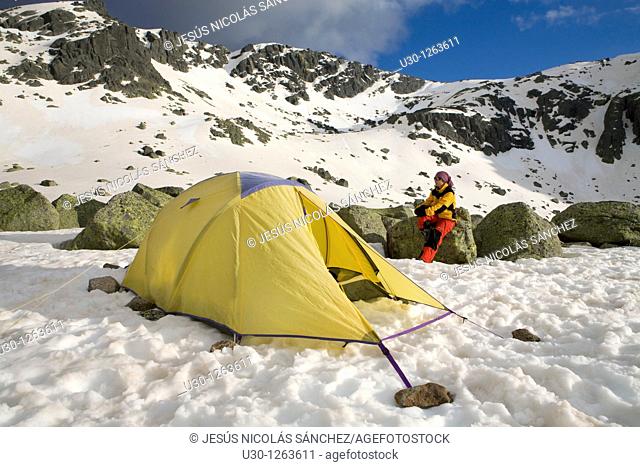 Mountaineer next to the yellow tent in the Sierra de Béjar Natural Park, in Salamanca province, Biosphere Reserve of Sierra de Béjar and Francia