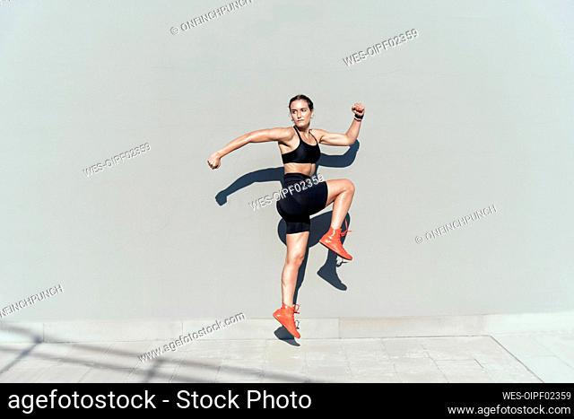 Young athlete jumping on sunny day
