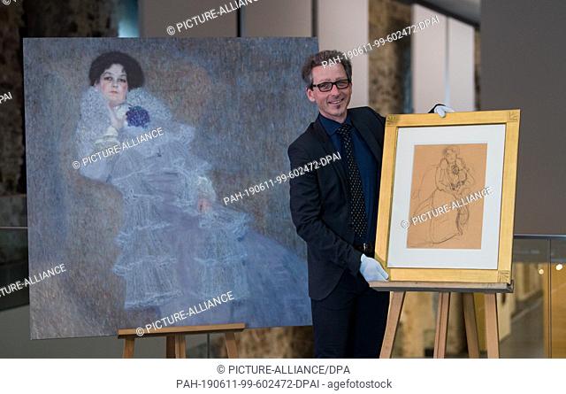 11 June 2019, Saxony-Anhalt, Halle (Saale): Thomas Bauer-Friedrich, Director of the Kunstmuseum Moritzburg, presents a reproduction of the portrait of Marie...
