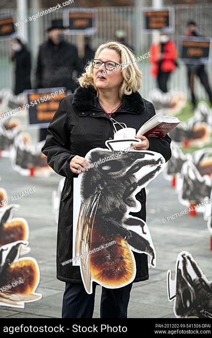02 December 2020, Berlin: Svenja Schulze (SPD), Federal Minister of the Environment, holds the cardboard display of a red wall bee at the protest action...
