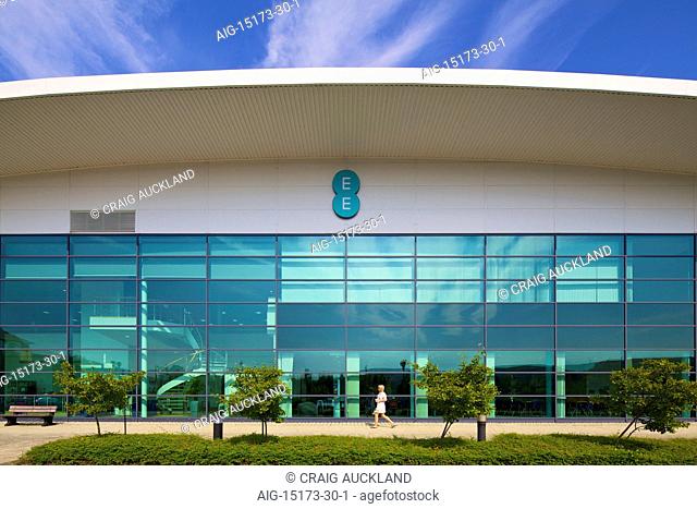 Everything Everywhere Office, Merthyr Tydfil. View of the building's exterior. Glass facade. EE sign hanging above the entrance