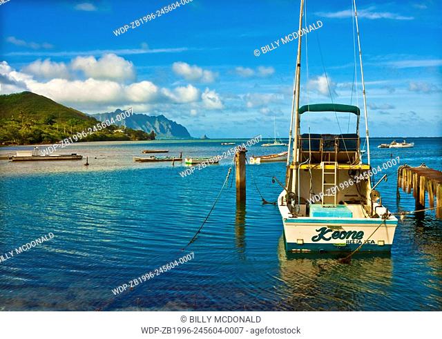 Charter Fishing Boat Moored at Heeia Kea Marina With Mokolii Island (Chinamans Hat) Across Kaneohe Bay, Oahu. Hawaii, USA