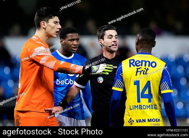 Jong Genk's goalkeeper Mike Penders, Jong Genk's Brad Manguelle, referee Laurent Willems and Beveren's Anthony Limbombe pictured during a soccer match between...