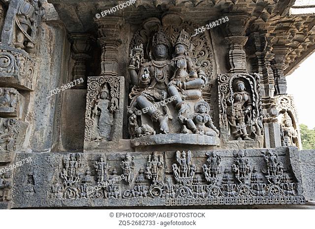 Sculptures on the façade, west side walls. Shiva-Parvati. Hoysaleshwara temple, Halebidu, Karnataka, india. view from West