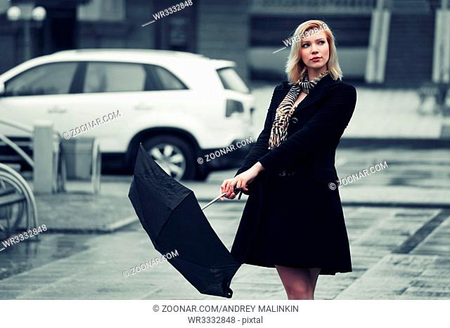 Young fashion woman with umbrella in the rain