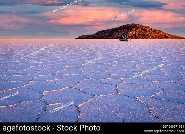 The sun rises over worlds largest salt lake Salar de Uyuni. Southwestern Bolivia is well-known for dramatic landscapes, lagunas, geysers and deserts