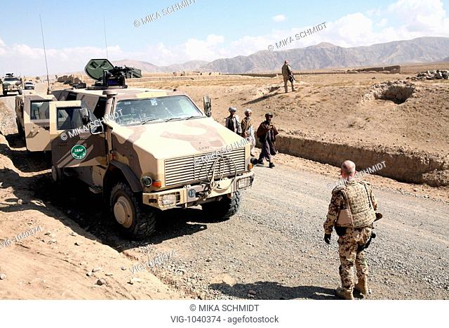German ISAF- soldiers between Kundus and Eshkamesh in front of a transport vehicle Dingo in the north part of Afghanistan