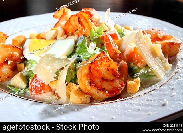 Salad from tiger shrimps, cheese and greens