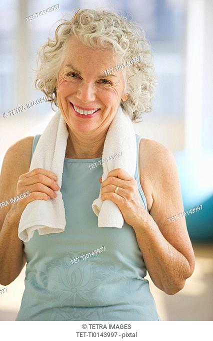 USA, New Jersey, Jersey City, Portrait of senior woman with towel at gym