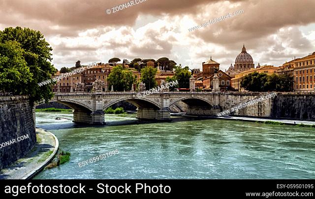 Tiber river, Ponte Sant'Angelo and St. Peter's cathedral by cloudy day, Roma, Italy