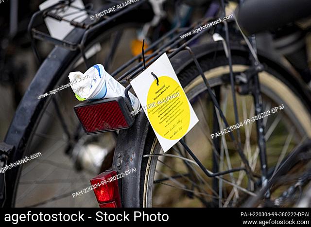 03 March 2022, Berlin: Several scrap bicycles stand at the Wedding S-Bahn and U-Bahn station with a sign for removal by the Ordnungsamt Mitte