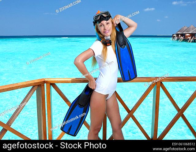 Young pretty woman with flippers, mask and tube. Maldives