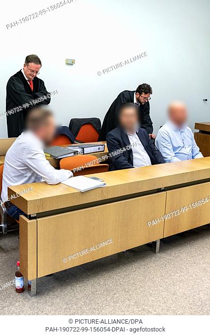 22 July 2019, Bavaria, Munich: Three managing directors of a Munich auction house sit with the lawyers Hannes Hartung (back