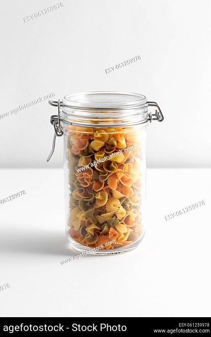 close up of jar with pasta on white table