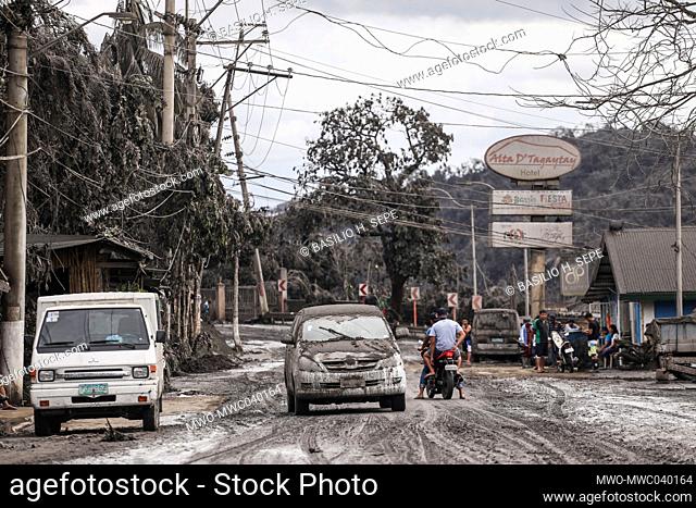 People on roads covered in volcanic ash during an eruption in Tagaytay, Cavite province south of Manila. Taal Volcano is a large caldera filled by Taal Lake in...