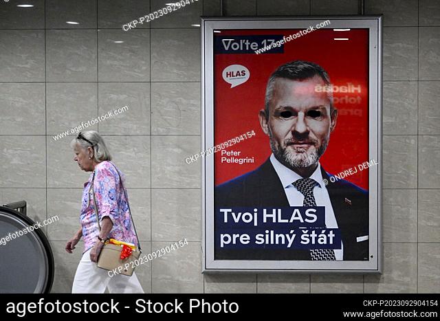 A woman walks past an election poster of the Voice of Social Democracy (Hlas-SD) party with former Prime Minister Peter Pellegrini, September 29, 2023