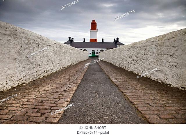 A path leading to a red and white lighthouse, south shields tyne and wear england