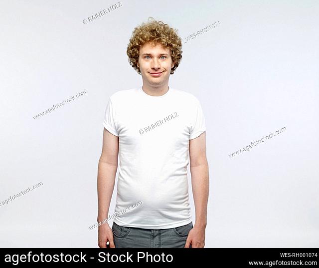 Portrait of smiling blond man wearing white t-shirt