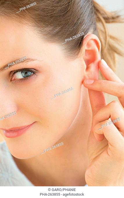 Woman massaging the ear lobe