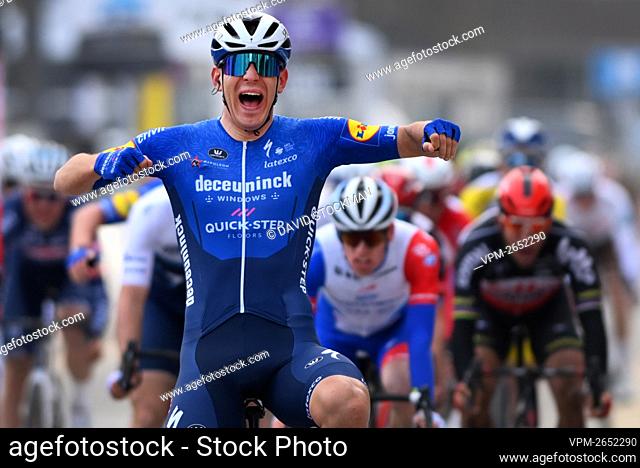 Italian Davide Ballerini of Deceuninck - Quick-Step celebrates as he crosses the finish line to win the men's elite race of the 'Omloop Het Nieuwsblad' one-day...