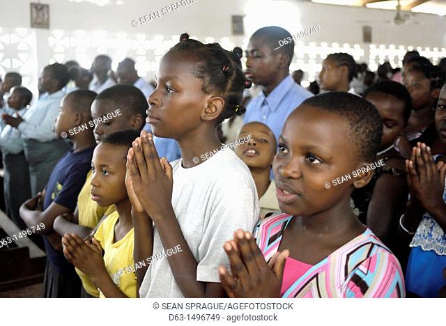 Children praying, Sunday mass at the Roman Catholic Parish of Buza, Dar es Salaam, Tanzania