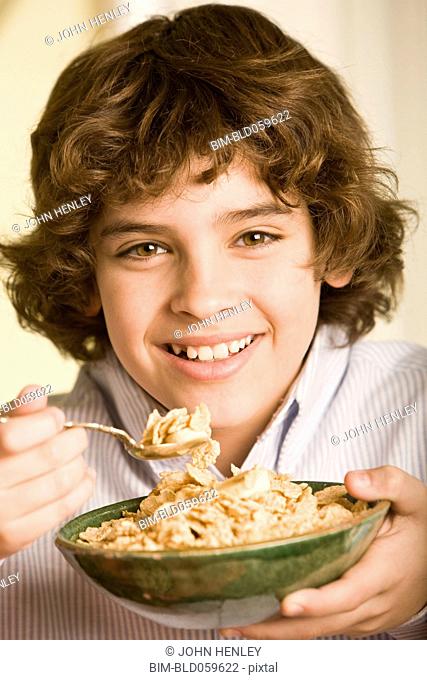 Hispanic boy eating cereal