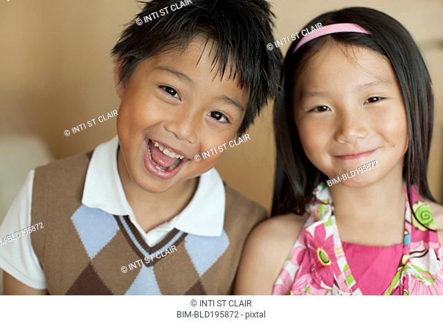 Smiling mixed race brother and sister