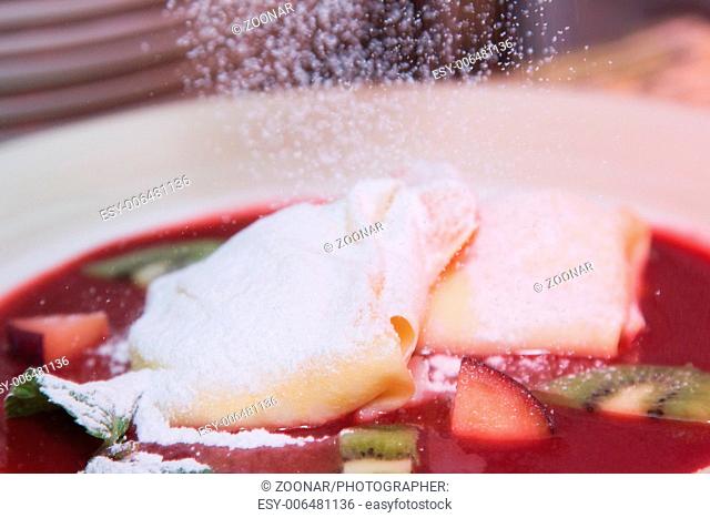 pancake with sweet jam in powdered sugar