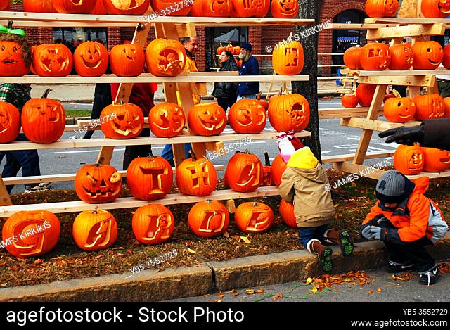 Kids enjoy carving their pumpkin at a festival in Keene, New Hampshire