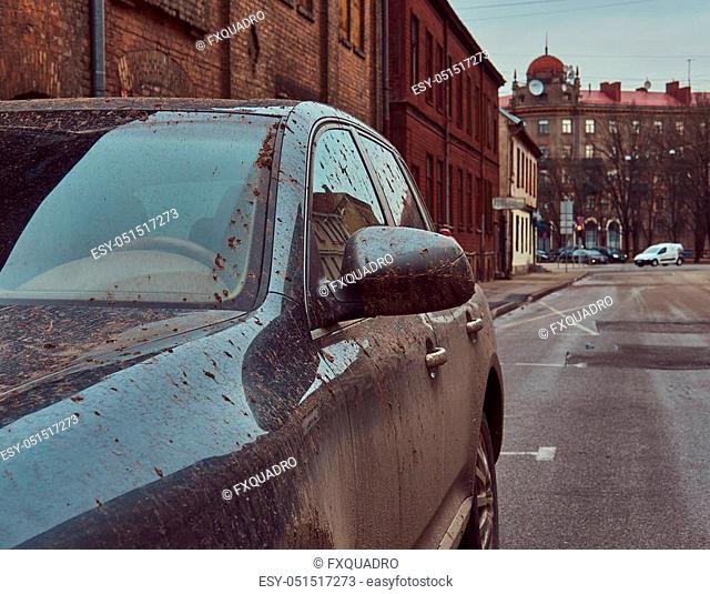 Image of a dirty car after a trip off-road. Stands against a brick wall in the old part of town