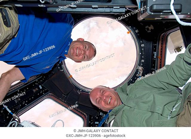 NASA astronauts Tony Antonelli (left), STS-132 pilot; and Garrett Reisman, mission specialist, pose for a photo in the Cupola of the International Space Station...