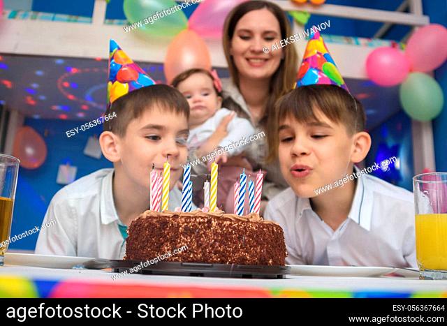 Children blew out candles on a holiday cake