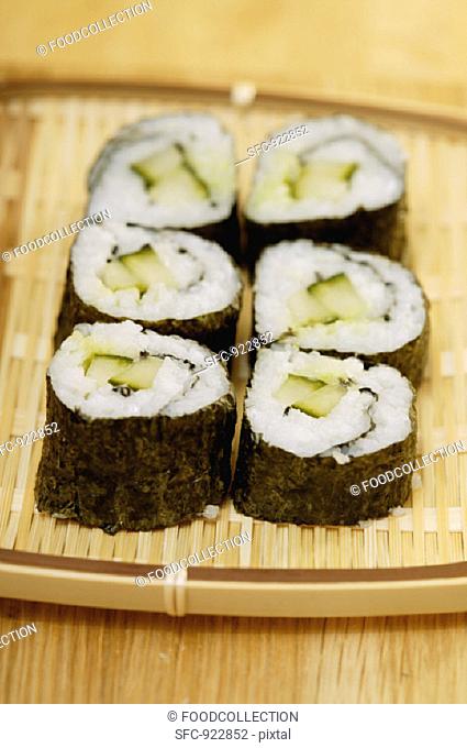 Maki-sushi with cucumber on wicker tray