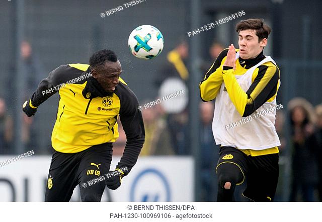 23 March 2018, Germany, Dortmund: Olympic gold medallist and world-renowned sprinter Usain Bolt scores a header during a training session of German Bundesliga...
