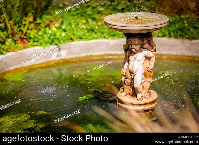 Small fountain in the Rookery in Streatham Common Park in London, UK