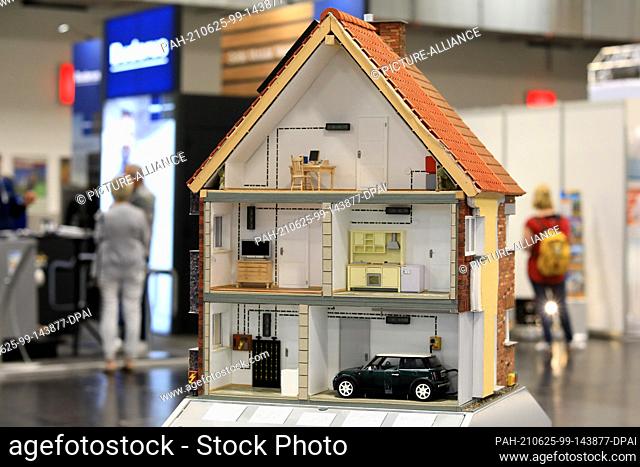 25 June 2021, Saxony-Anhalt, Magdeburg: A model house stands in exhibition hall 1 at the Landes-Bau-Ausstellung (LBA), which begins today in the state capital