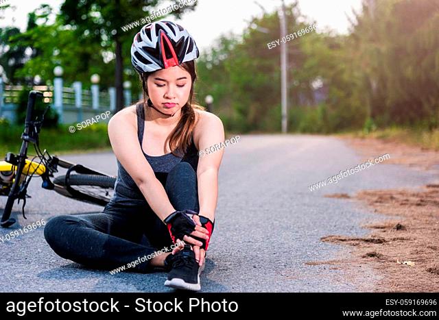 Beautiful young female woman pain injured accident sitting after bicycle falling with copy space