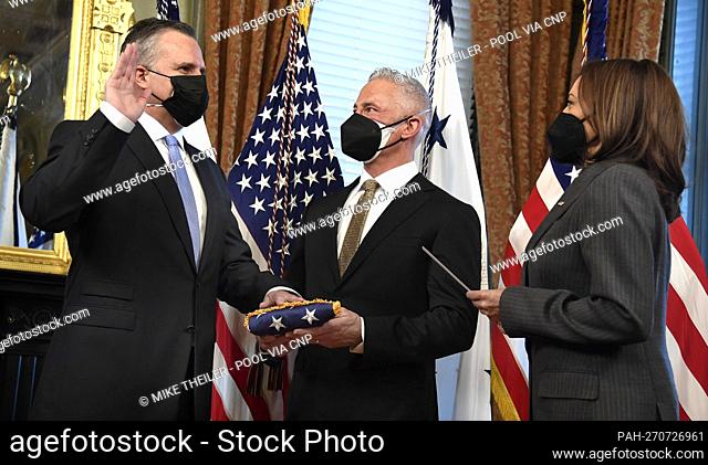 United States Vice President Kamala Harris (R) conducts the swearing in of the State Department's Chief of Protocol Rufus Gifford (L) as his husband Stephen...