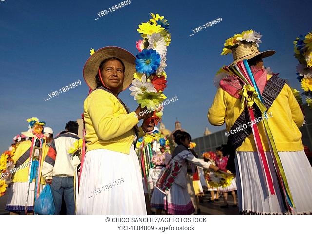 An indigenous Mazahua woman from San Pedro el Alto, San Felipe del Progreso, Estado de Mexico carries a crown of flowers as part of the Danza de las Carmelitas
