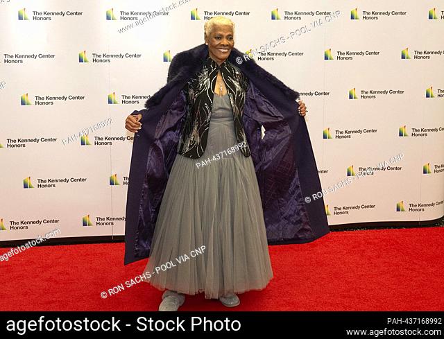 Dionne Warwick opens her coat to show-off her dress as she arrives for the Medallion Ceremony honoring the recipients of the 46th Annual Kennedy Center Honors...