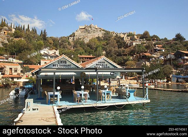 View of the traditional houses and local restaurants in Kalekoy with the Simena Castle at the background, Ucagiz village, Demre, Antalya Province
