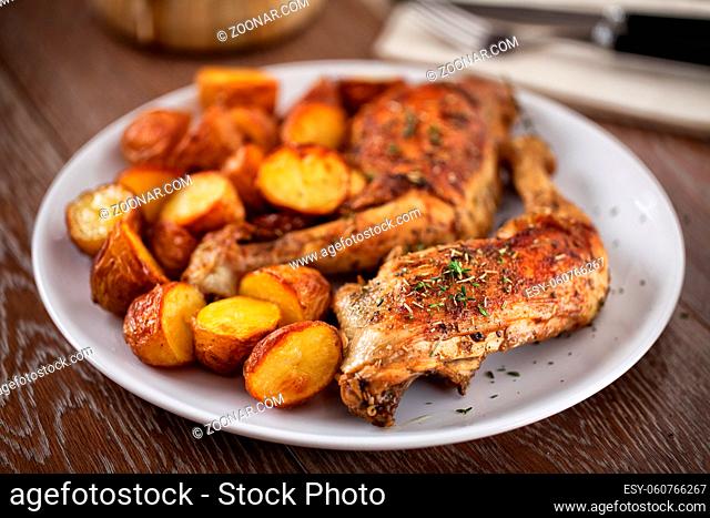 Roast Chicken Thighs with Potatoes on a Plate