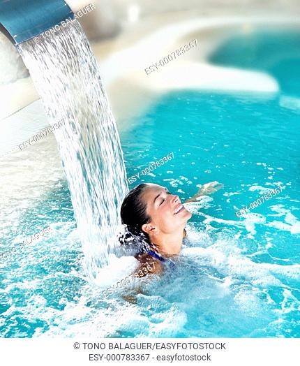spa hydrotherapy woman waterfall jet turquoise swimming pool water