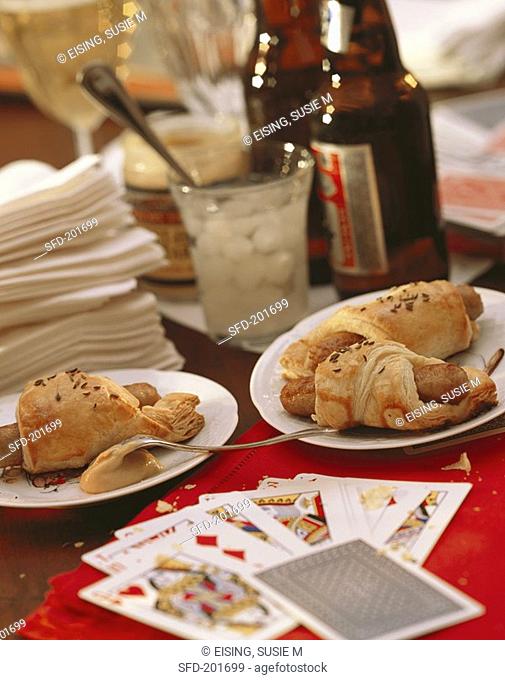 Party Table Scene with Pigs in a Blanket and Beer, Cards