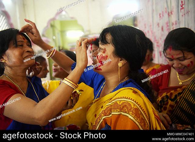 Female devotees share Sindur, red holy powder with each other at the Lakshmi narayan temple for the good of the family on the occasion of Pohela Boishakh
