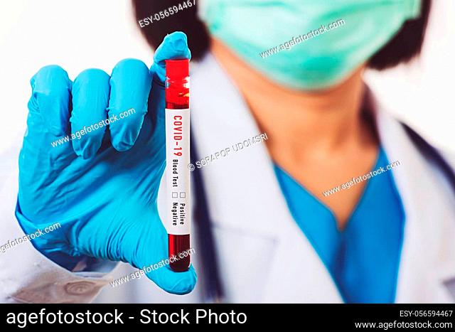 Doctor scientist in white uniform wear a mask holding test tube Coronavirus test blood sample in a clinical laboratory for analyzing isolated on white
