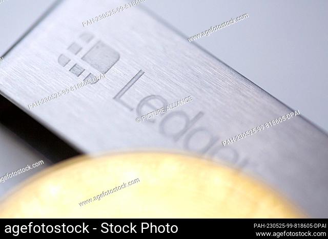 ILLUSTRATION - 22 May 2023, Berlin: A bitcoin coin sits on a Ledger stick, a product of Ledger, a company that provides hardware wallets for cryptocurrencies