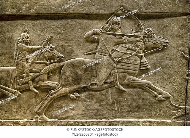 Assyrian relief sculpture panel of Ashurnasirpal lion hunting. From Nineveh North Palace, Iraq, 668-627 B. C. British Museum Assyrian Archaeological exhibit no...